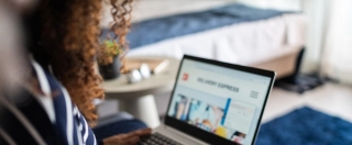 Young woman online shopping using the laptop at home.
