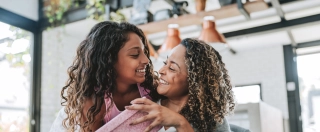 Daughter presents a gift to her mother.