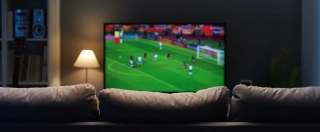 Football match on widescreen flat TV at home, sport and entertainment concept.