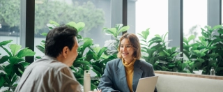 Business persons working in a modern green office.